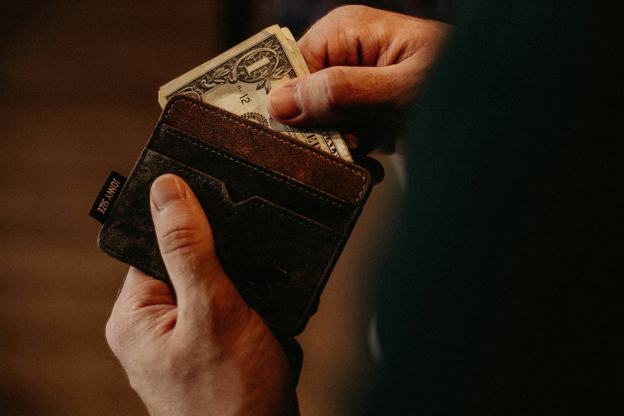 Money being taken out of a wallet.