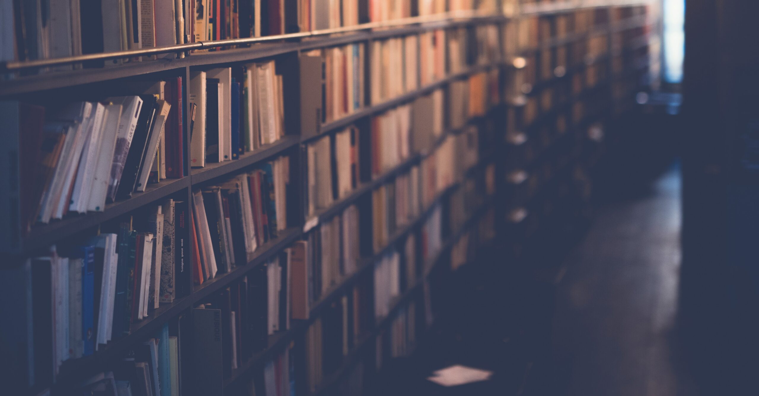 A row of bookshelves in a library.