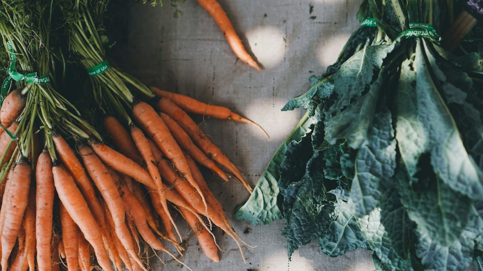 Carrots and lettuce placed on a table.